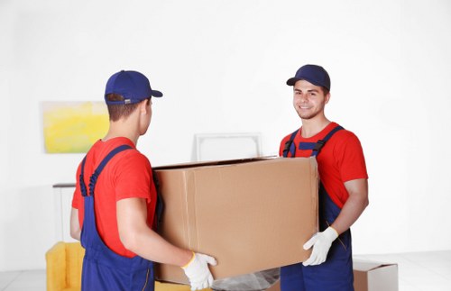 Professional packers organising household boxes in a Greenwich home