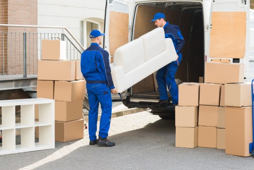 Moving crew managing access and bulky items at a Greenwich property
